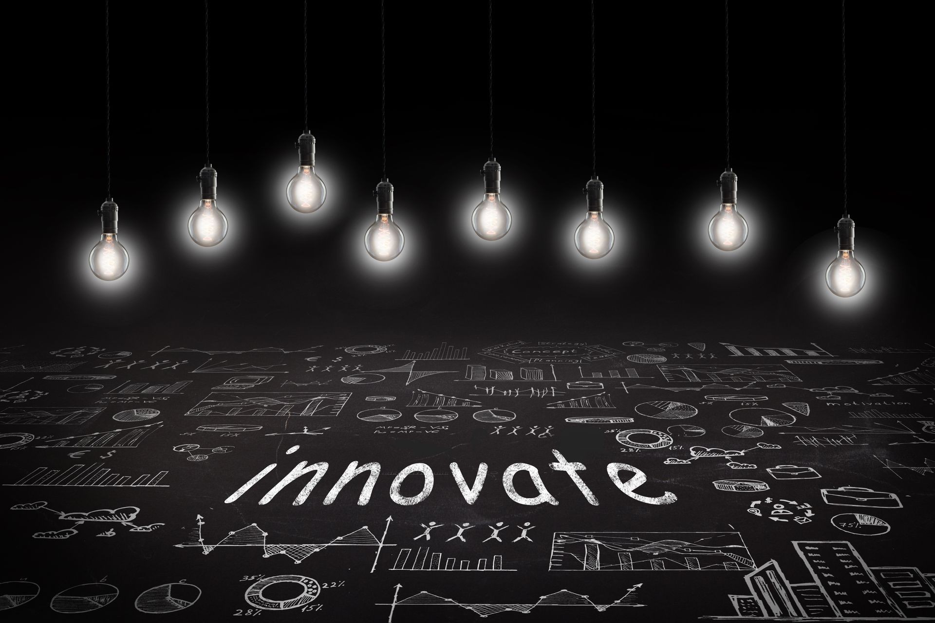 Business concept - word 'Innovate ', sketch with schemes and graphs on chalkboard